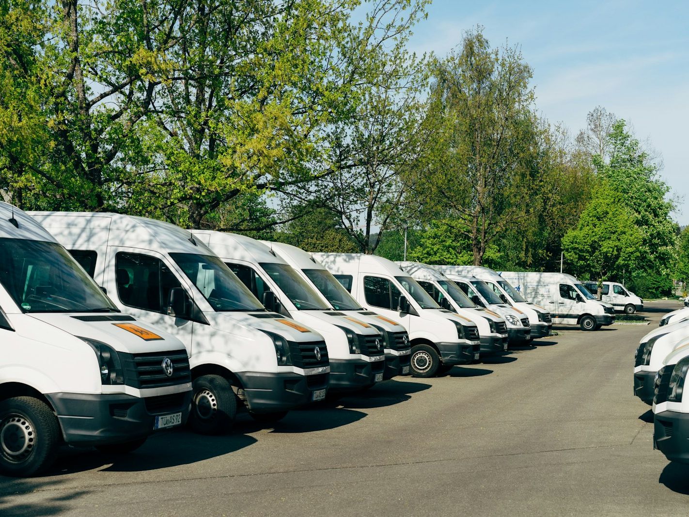 Row of white commercial work vans