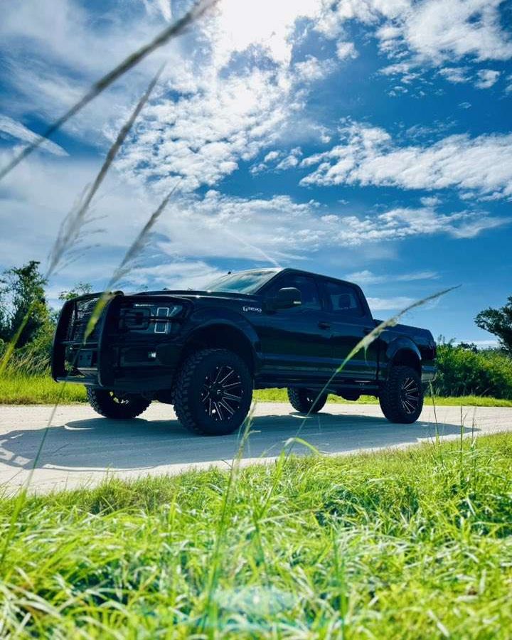 Black Ford F-150 on aftermarket wheels and tires